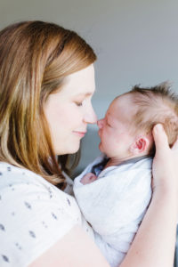 mom and newborn baby boy nuzzling noses